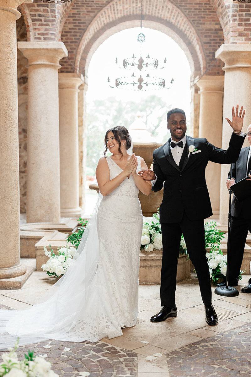 Bride and Groom waving at their guest after getting married at alter