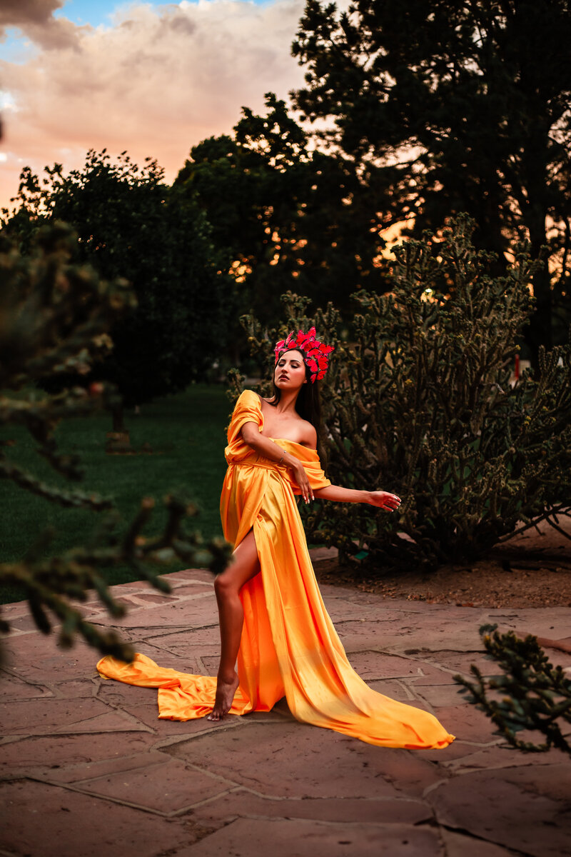 woman in fabric drape and butterfly headpiece at sunset photo