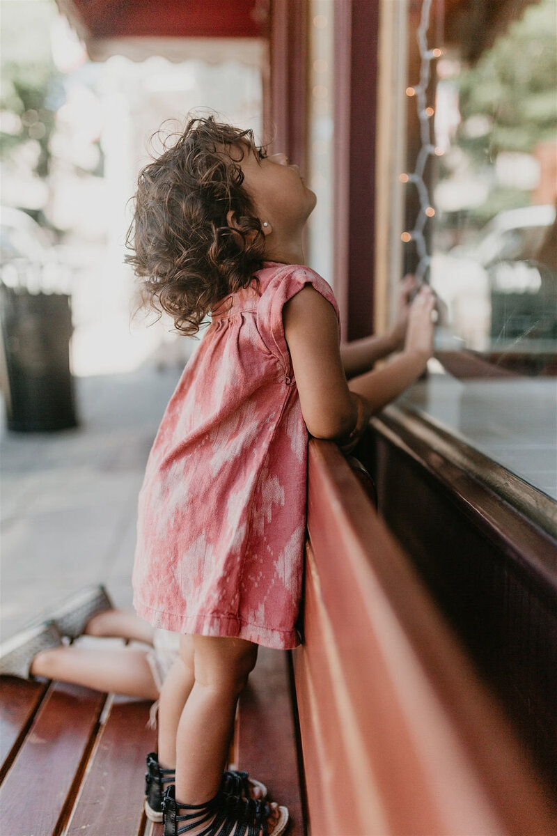 child looking in a window