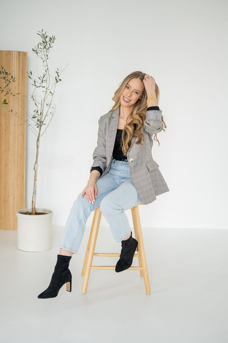 Emma Saltd Studio smiling on stool