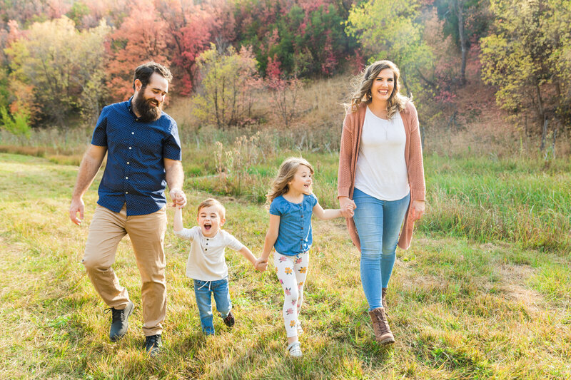 family smiling and walking together in Utah