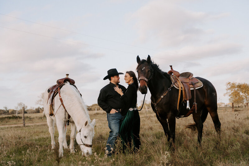 couple riding horses kissing