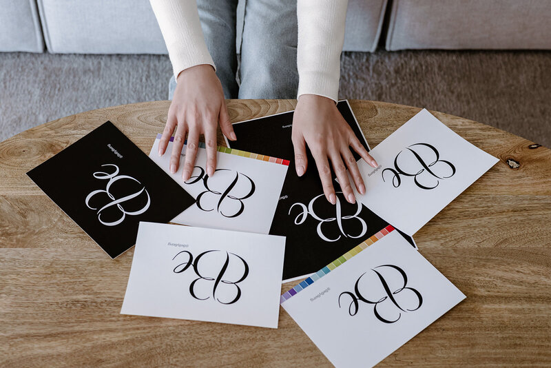 paper on the table with the business logo on and hands touching the paper