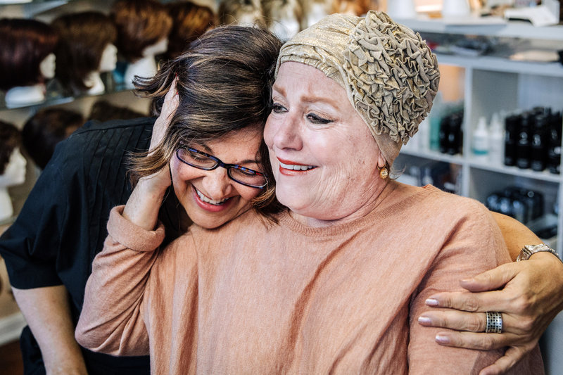 The Hair Lady, Katherine Fagan, hugs a client. Wigs, Hair, Alternative Hair, Products, Shop, State College, PA