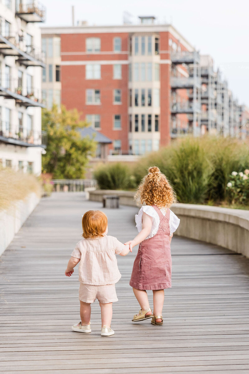 Two sisters holding hands in Third Ward Milwaukee, Wisconsin Family Portraits