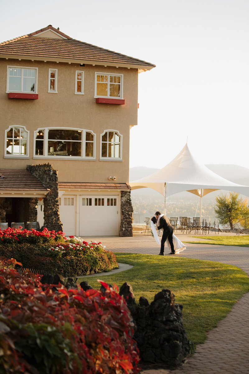 Spokane fall Wedding photo of bride and groom. Bride wearing a classy low back simple white dress from honest in ivory spokane. groom wearing black tuxedo from tuxedo gallery. Bride and groom walking down the aisle after saying I do, groom kissing brides hand. Wedding at the Ridge at Greenbluff, Spokane Washington. Photo by Shanoah Bri Photography, wedding photographer in spokane. Shanoah Bri Photography, Spokane wedding photographer.