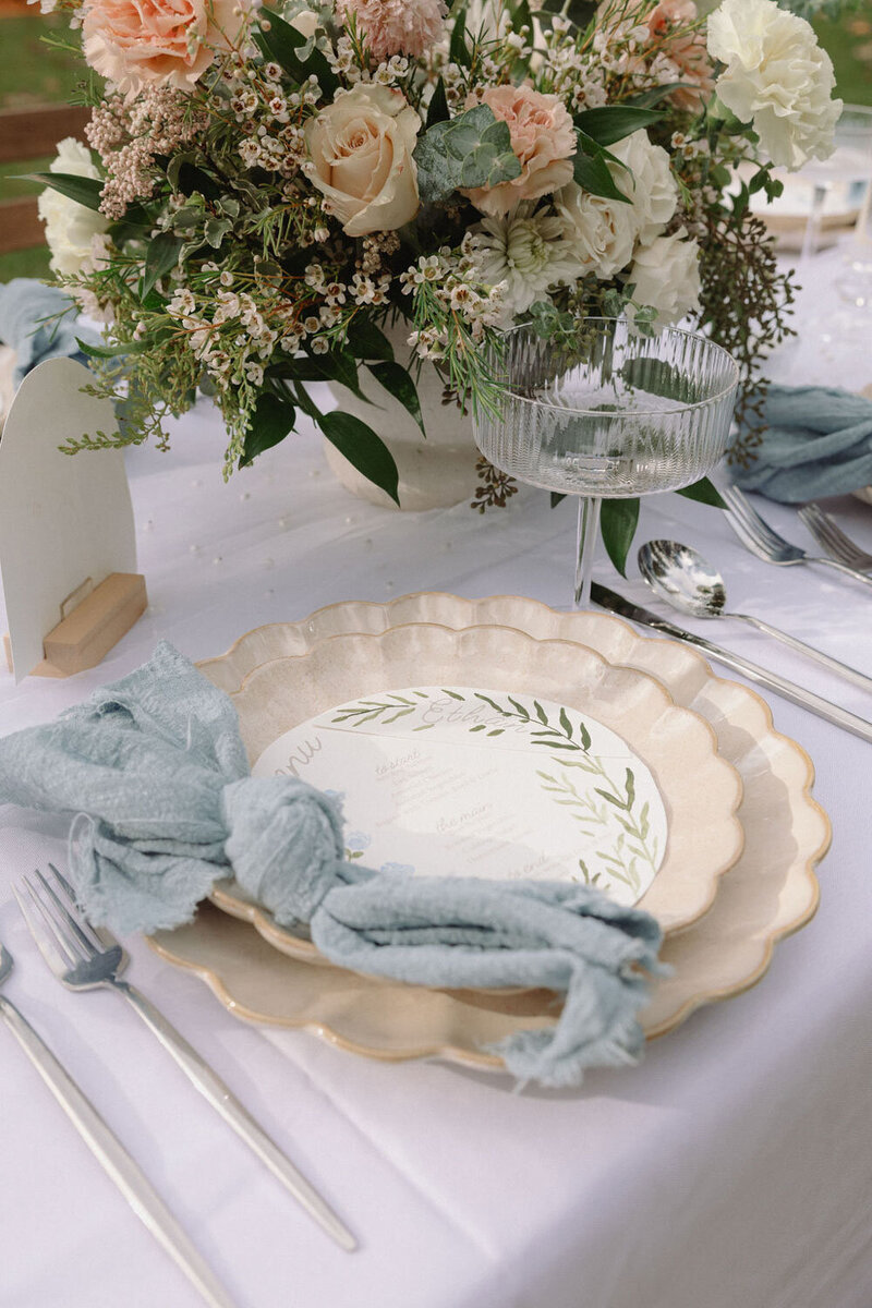 Elegant tablescape with blue linens and floral centerpiece