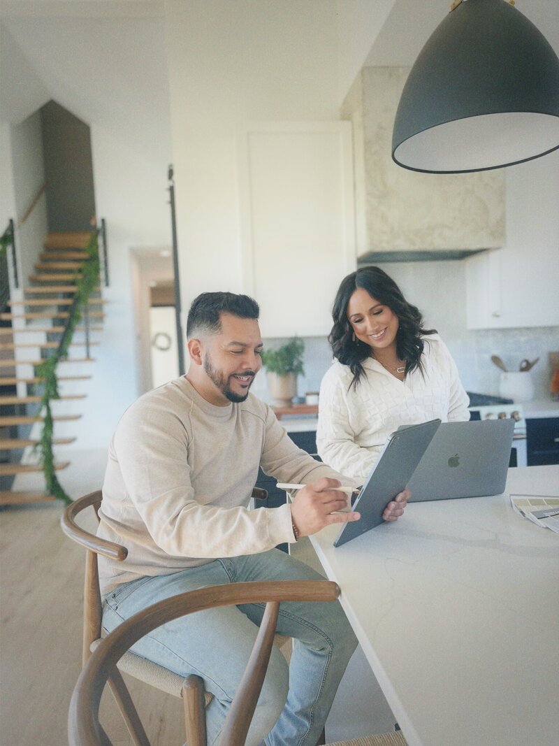 husband and wife interior design team work in a modern farmhouse kitchen