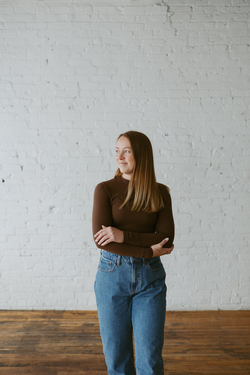 girl on beige couch for portraits in Wisconsin studio