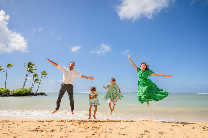 Maui family vacation photography beach jumping session - professional island photographers capturing joyful family moments