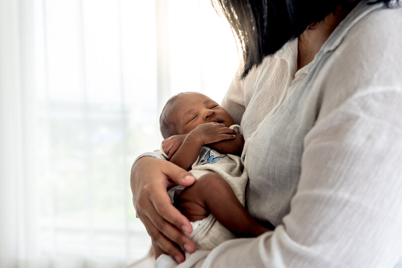 Mom putting baby to sleep