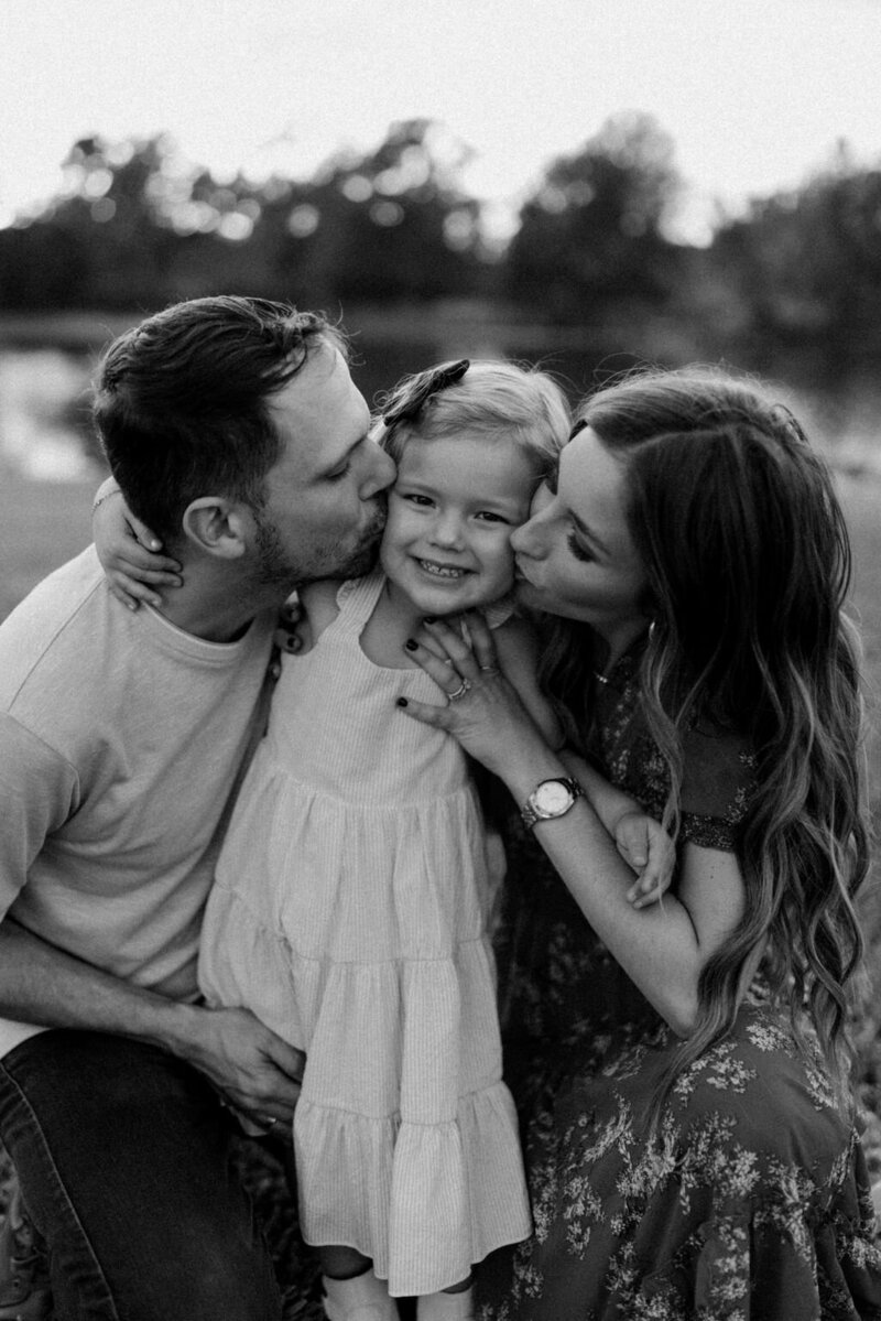 Parents Kissing Daughter Family Photos