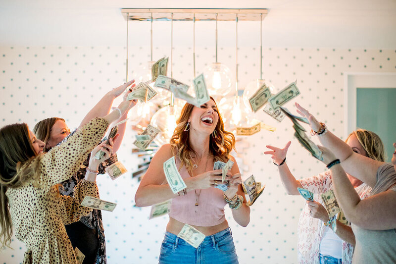 Emily being showered in money