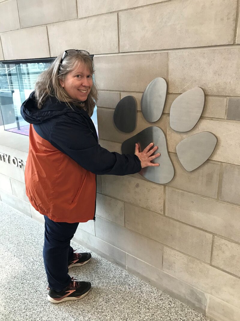 Lisa compares the size of her hand to a giant University of Kentucky Wildcat pawprint.