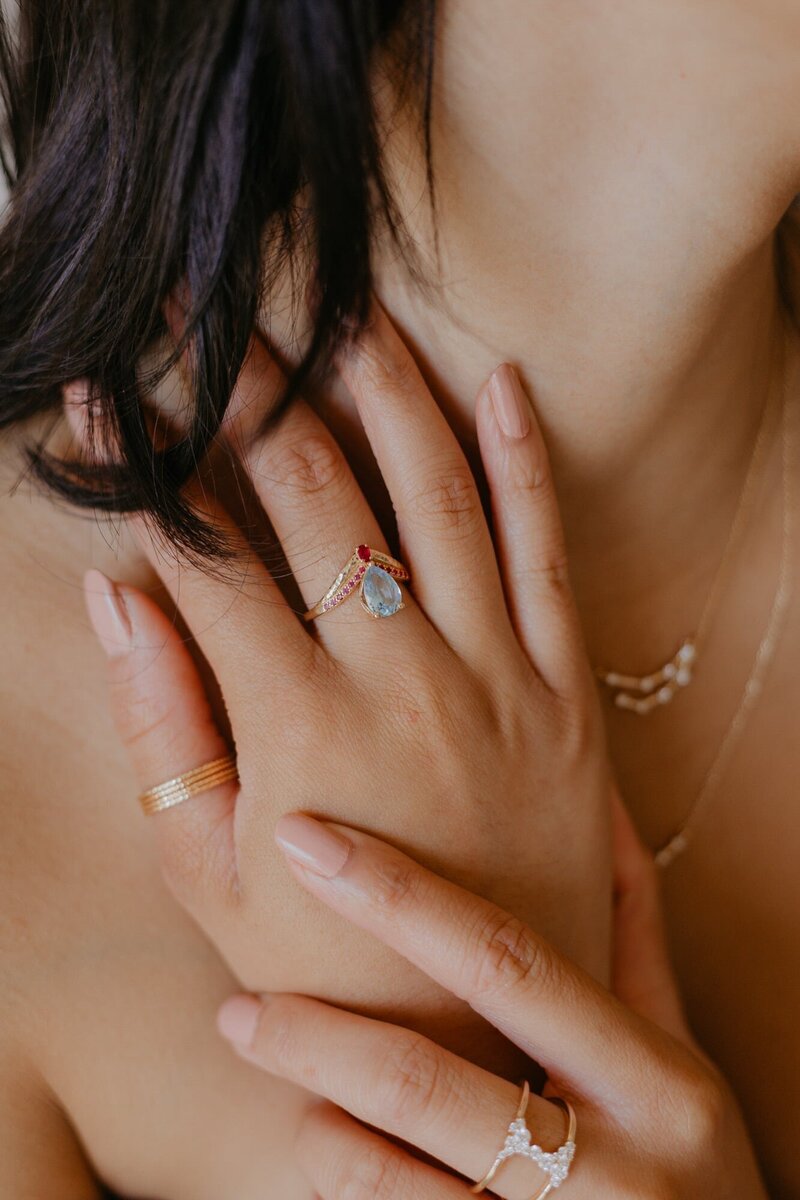 Solid gold aquamarine ring with ruby side stones