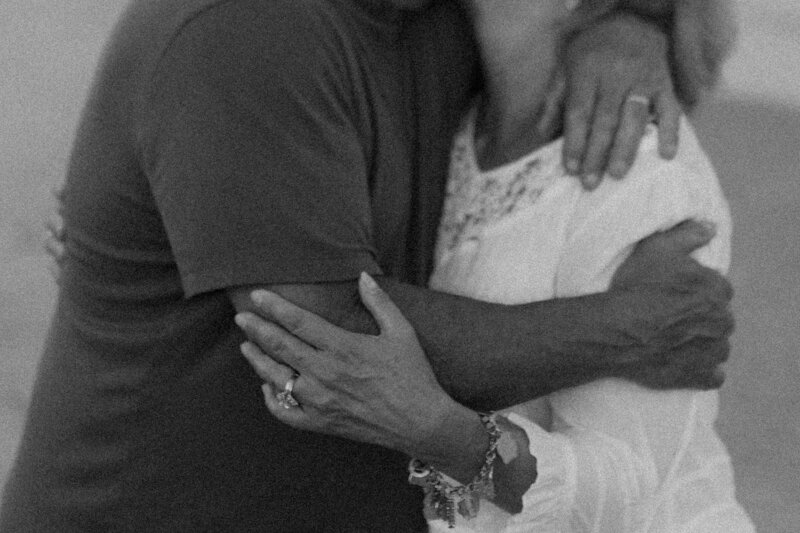 Two parents embrace during their extended family beach photoshoot at Virginia Beach