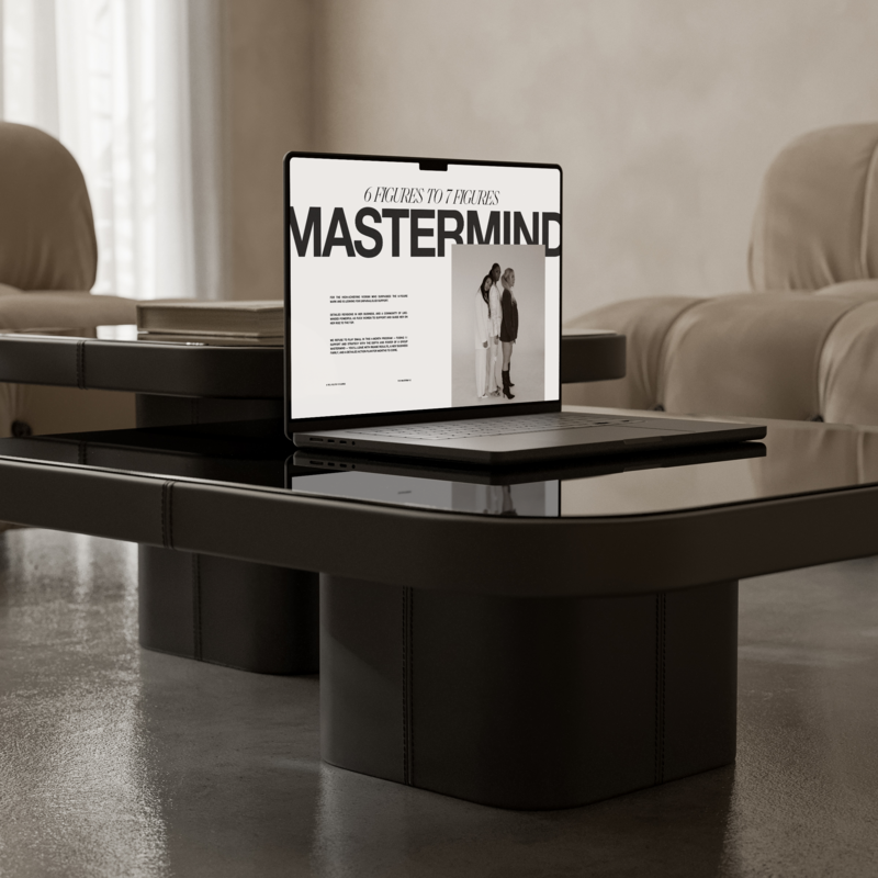 a macbook on a table with a mockup of 7 figure business mentor natasha zoryk's 6 figures to 7 figures mastermind