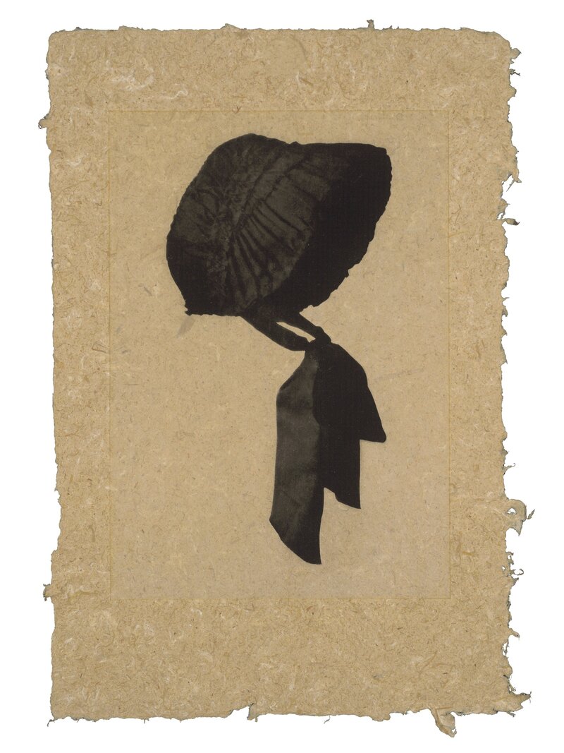 Photogravure print by Trina Michelle Robinson featuring a black bonnet silhouette on natural-toned raffia palm paper.