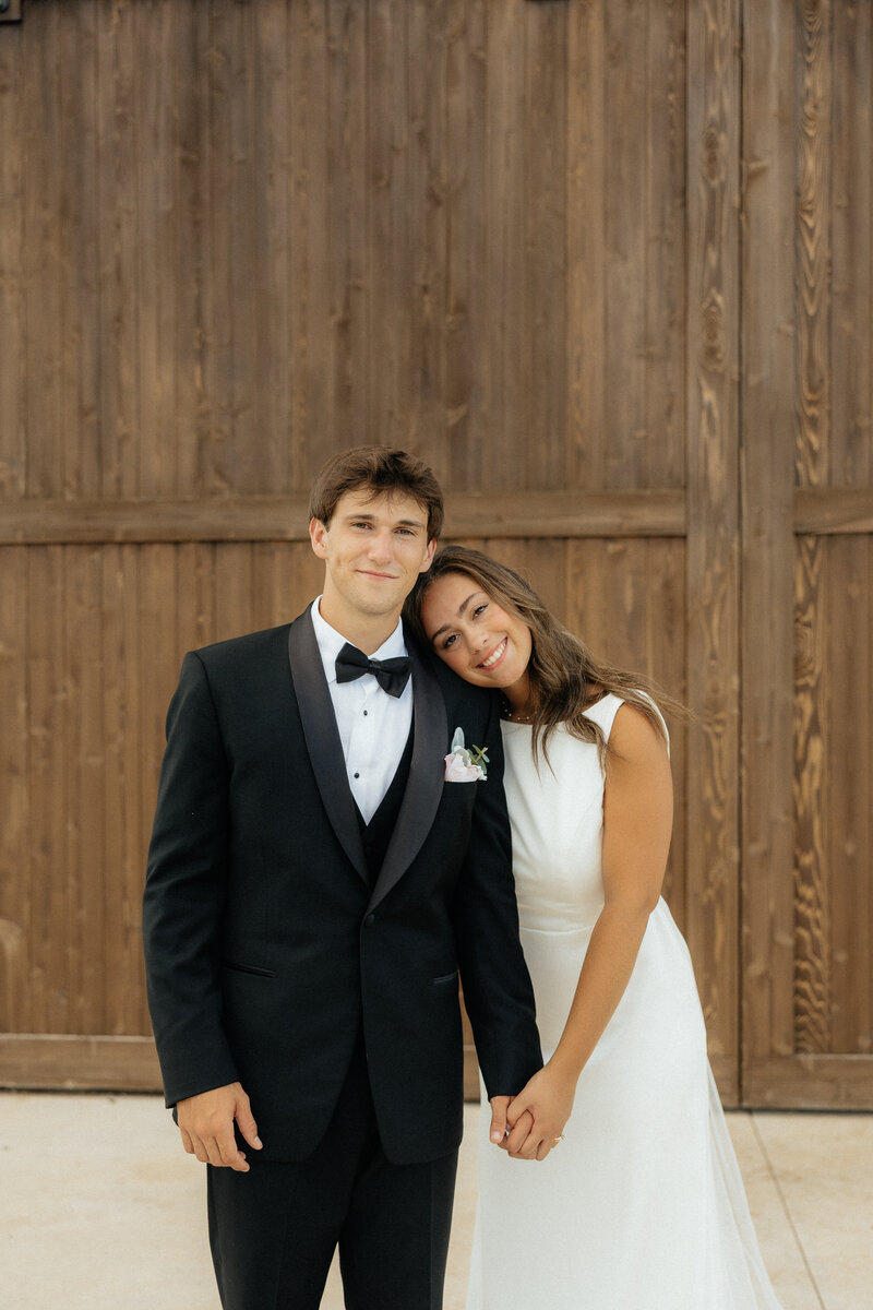 Christian and Olivia standing in front of the Farmhouse Barn.