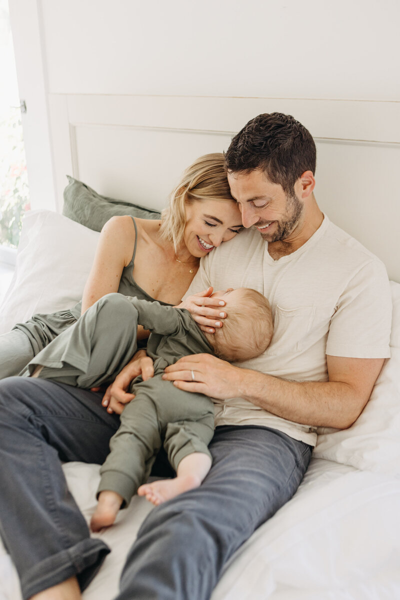 Sweet family photographed snuggling at home lifestyle session.