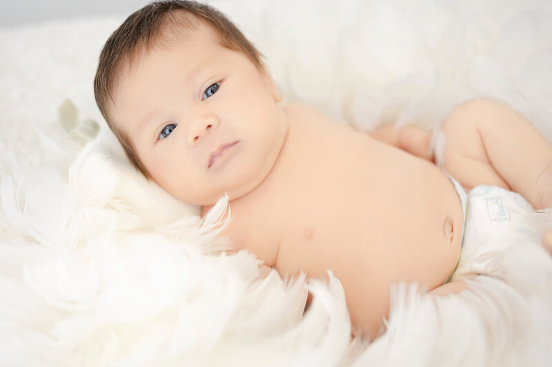 Newborn baby boy wide awake for his session at Heather Nicole Photography.