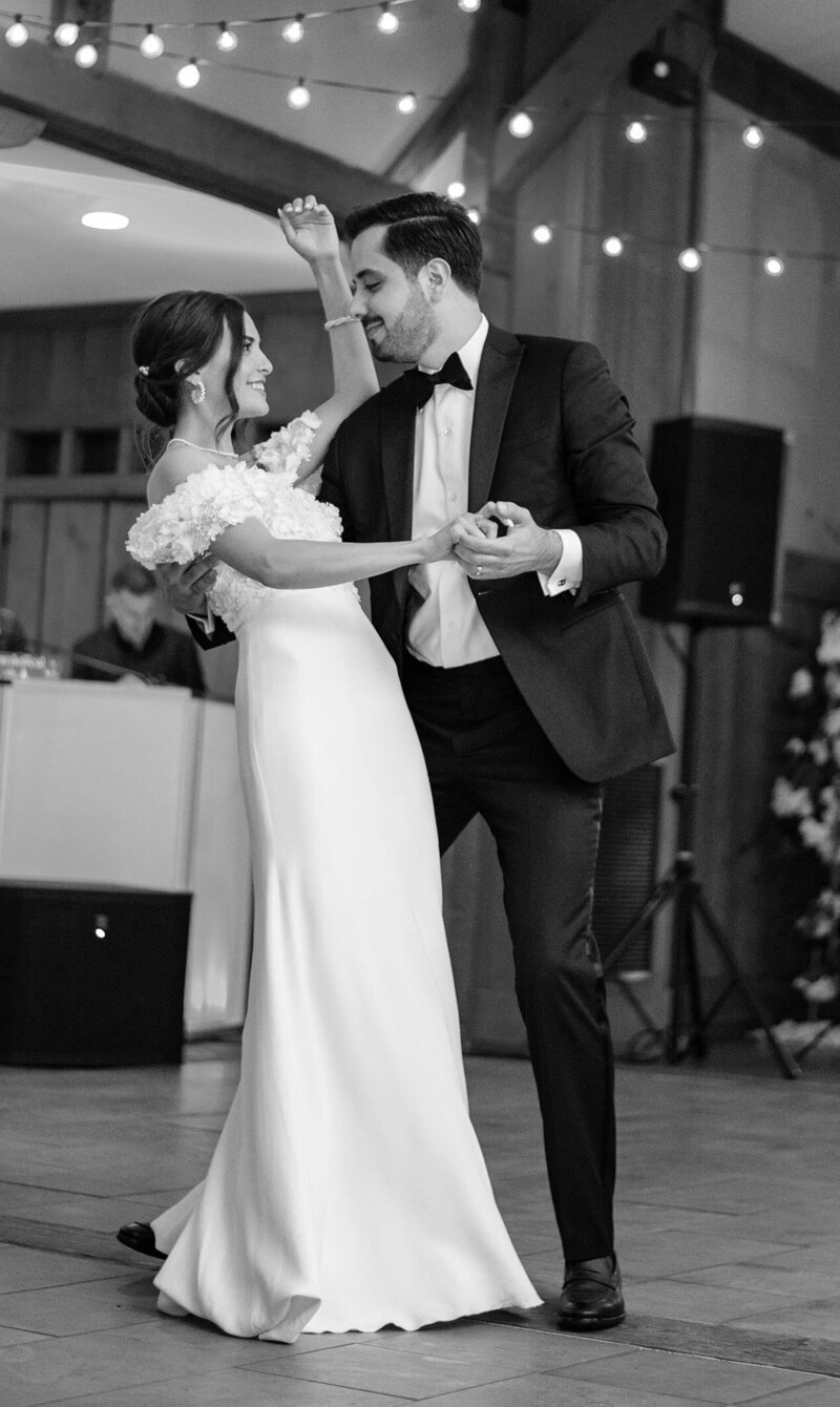 Attractive young Turkish couple in black tie wedding during their first dance displaying a chic style.