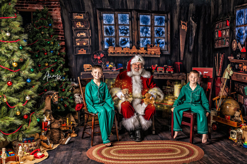 Two boys in green pajamas with Santa and magical sparkle around them