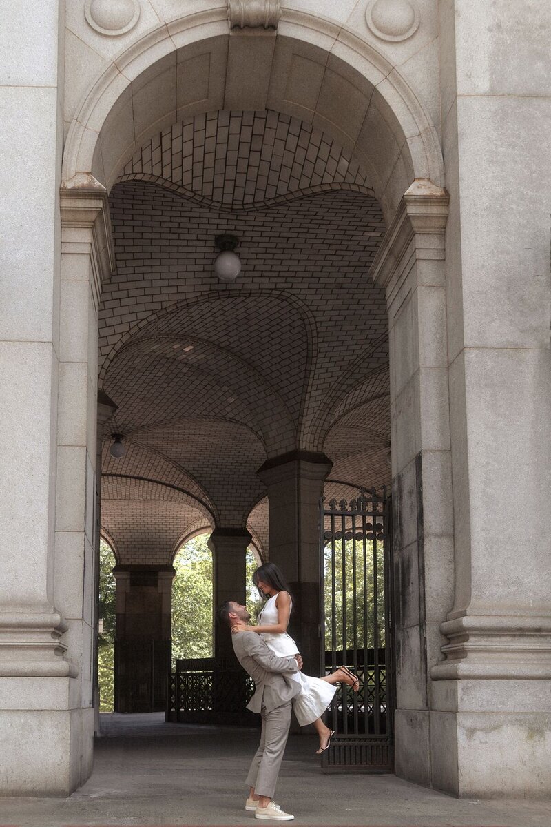 Asian bride being kissed and dipped in front of sparking fountain at Marina del Ray's venue.