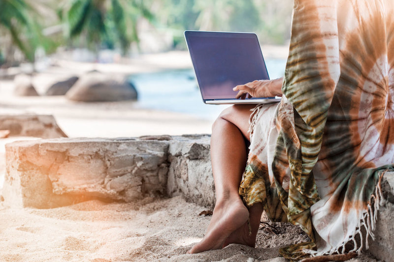 Amber Bennett Life Coaching boho digital nomad on laptop