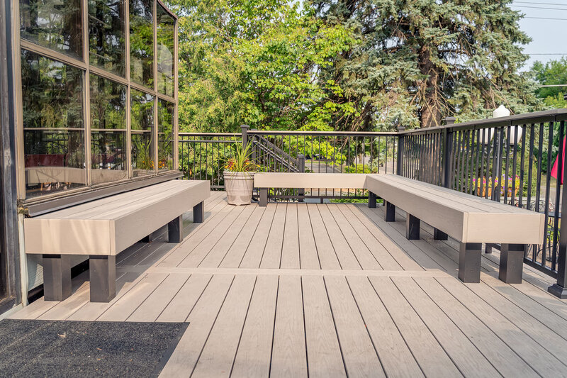 Front deck seating area of Adele's Frozen Custard with coordinating built-in benches using the same PVC decking from TimberTech. 