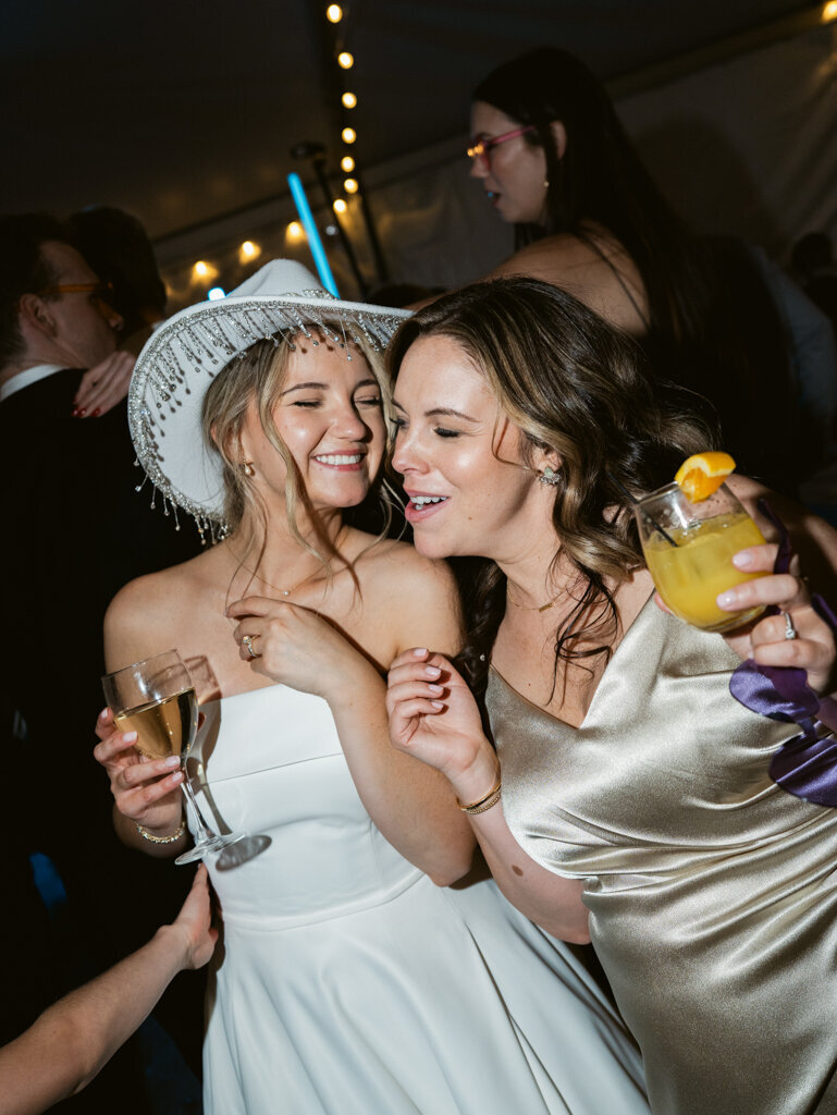 bride dancing with friend during wedding reception taken by Baltimore wedding photographer