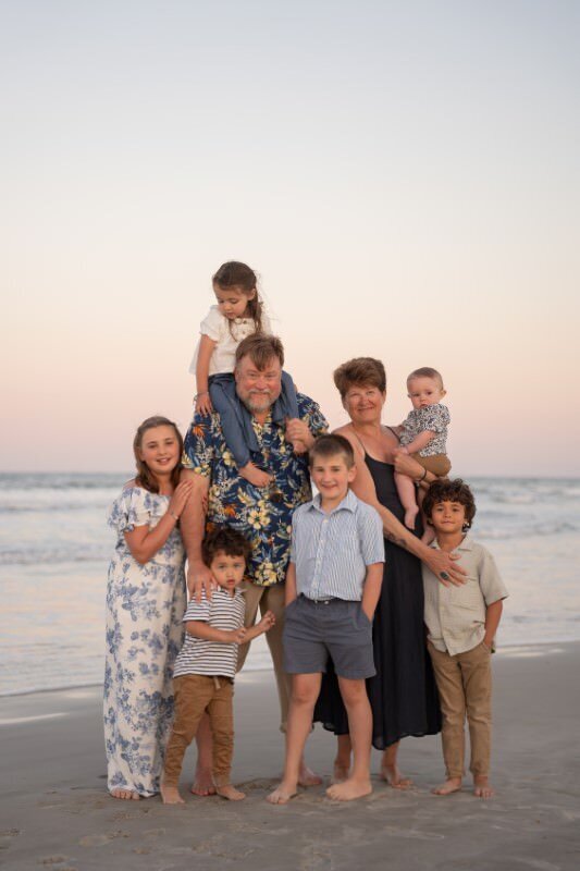 grand-parents-and-grand-kids-pose-for-a-family-beach-portrait-at-sunset