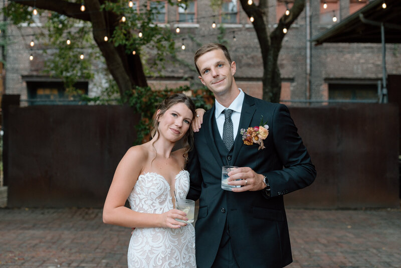 A married couple enjoying their favorite cocktails after their wedding in the West Bottoms.