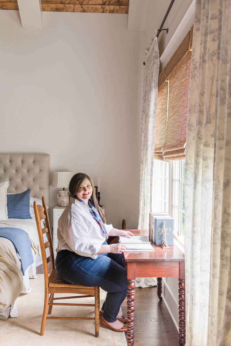 Lauren sits at her antique wooden desk in her bedroom with journal