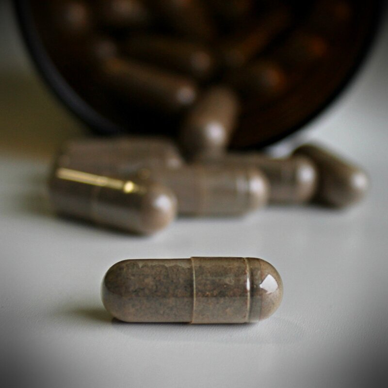 Close-up of placenta encapsulation pills on a white surface