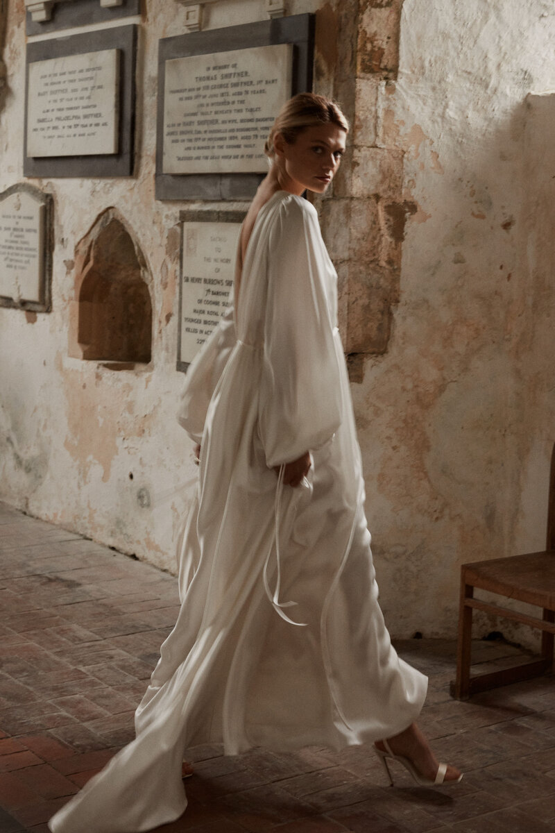 Benjamin Wheeler photography of bride wearing long-sleeved, elegant low v neck silk wedding dress