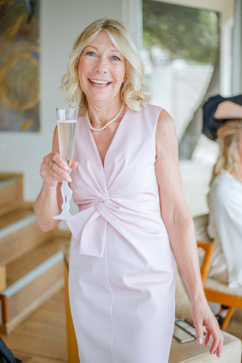 mother of the bride holding a glass of champagne