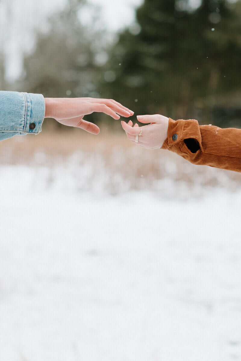 Couple reaching toward each other with their hands by Nashville wedding photographer