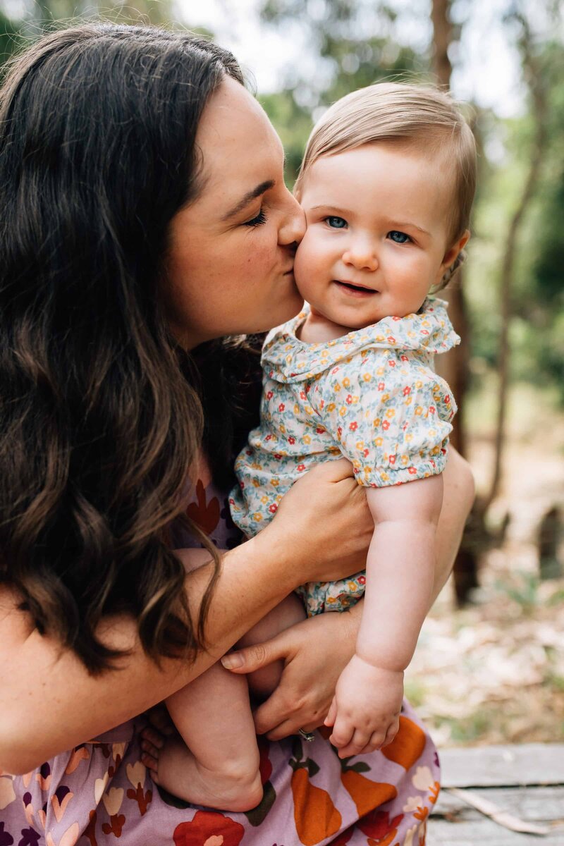Mum kissing toddler daughter on cheek, Melbourne family photoshoot