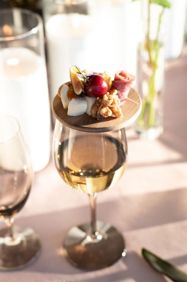Wedding planner in Houston smiling with a bottle of champagne.