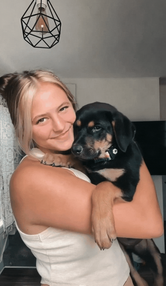 Izzy Waite owner of Izzy Waite Design holds a foster dog