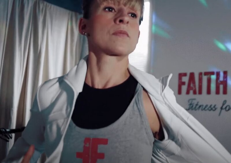 A person taking off their jacket in the gym 