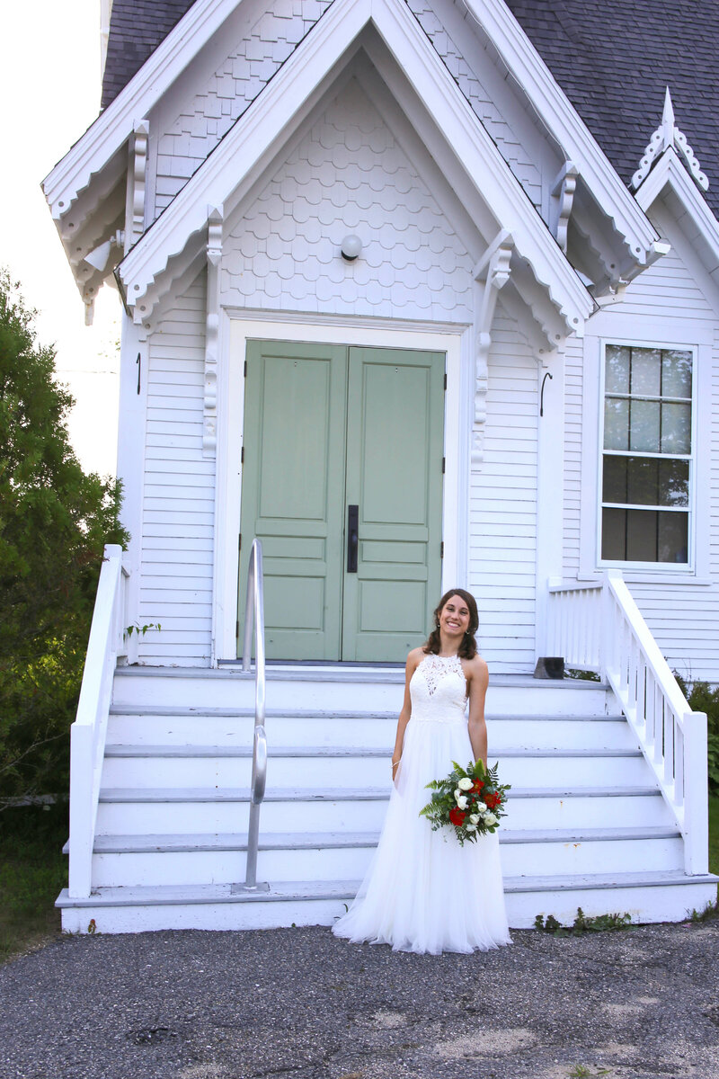 Bride standing with bouquet outside of church | Maine Wedding Photography