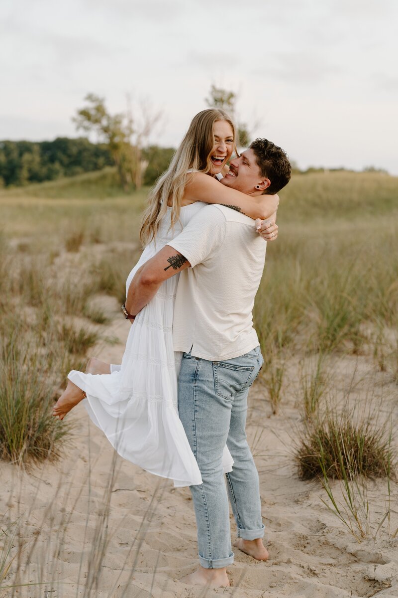 playful couples photos on the beach of Michigan