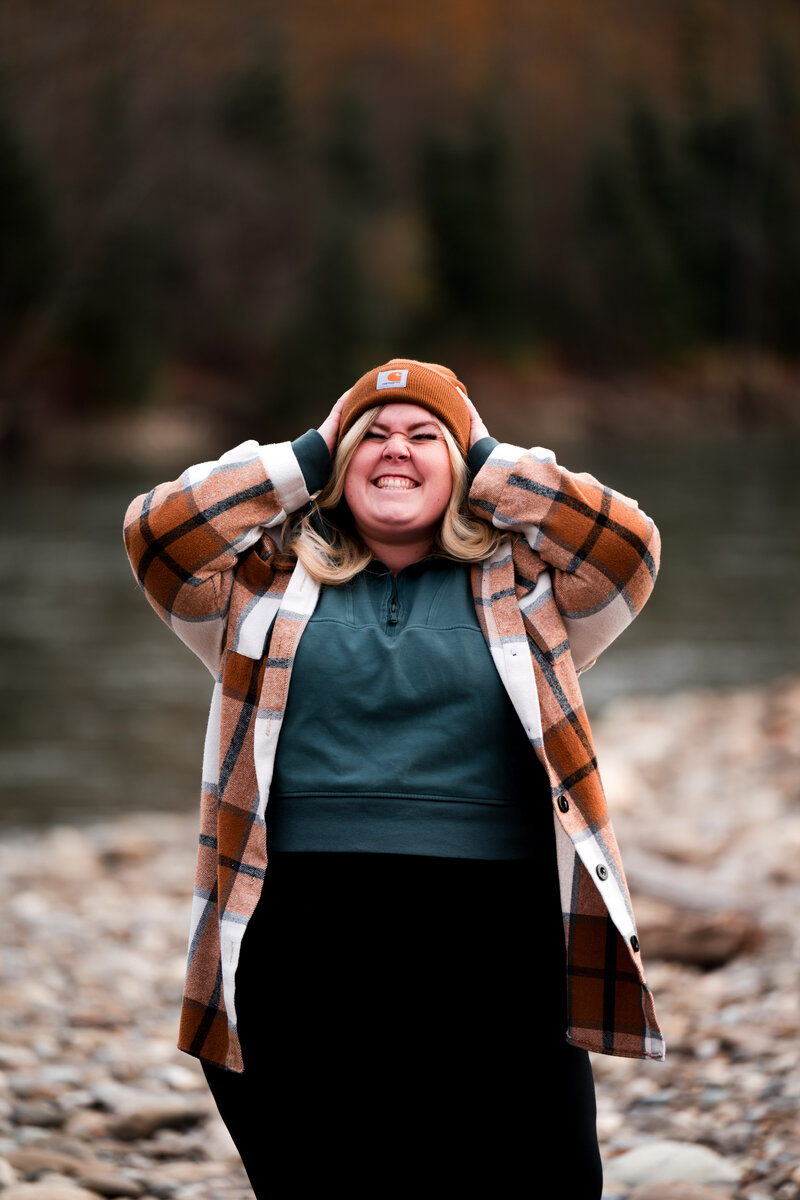 edmonton wedding photographer dressed to go on a hike smiling and having fun in nature
