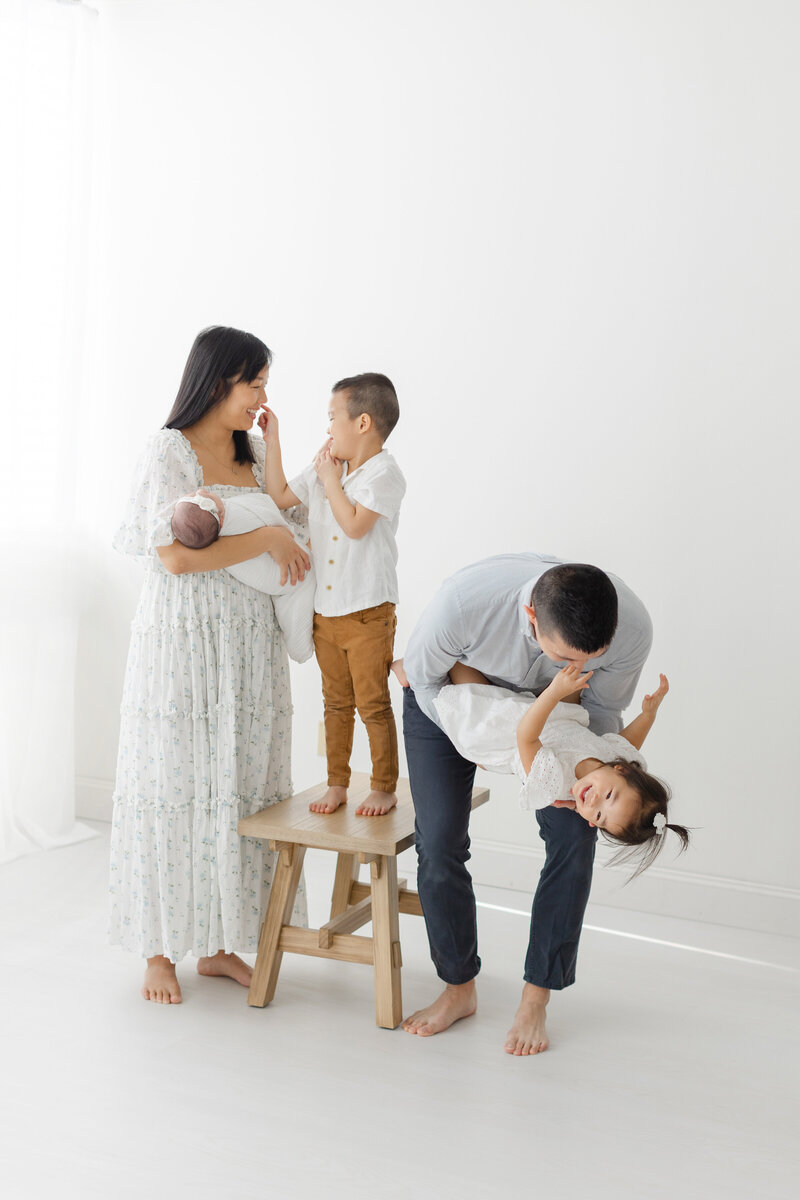 Young family takes candid newborn portrait in photography studio