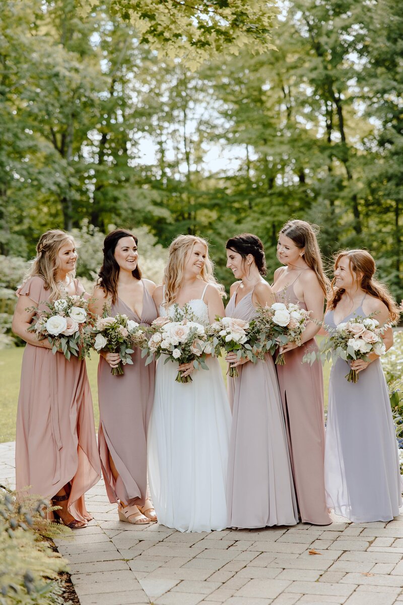 bridesmaids smiling in pastel dresses