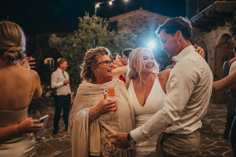 bride and groom hug bride's mother