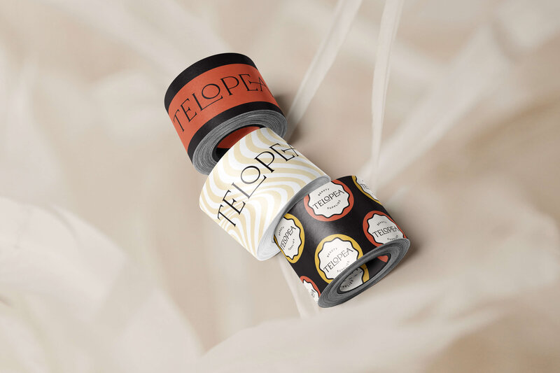 Telopea Beauty Supplies packaging tubes and labels, designed with bold red and black accents, emphasizing the brand’s creative and cohesive packaging identity.