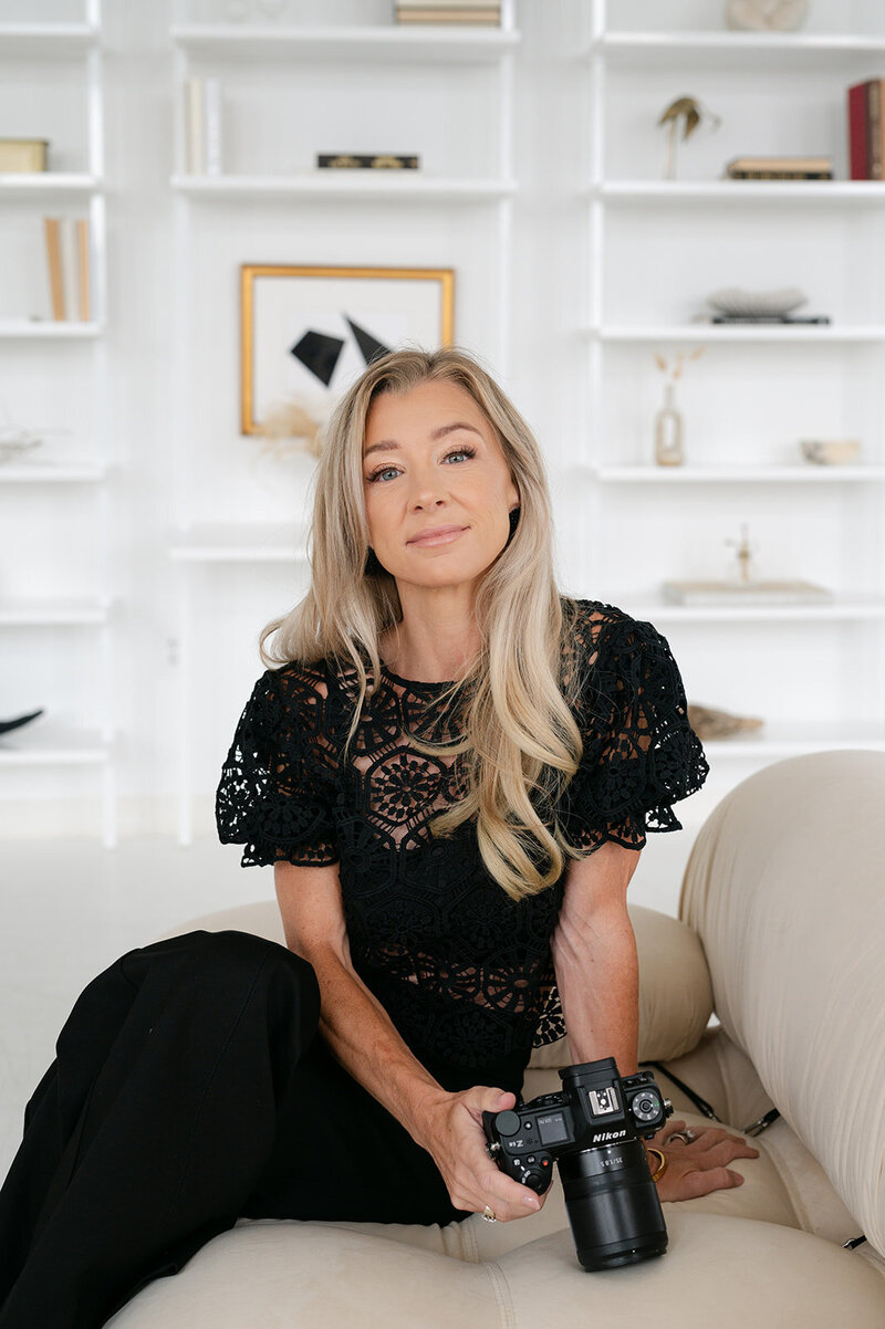 a woman smiling in a black outfit